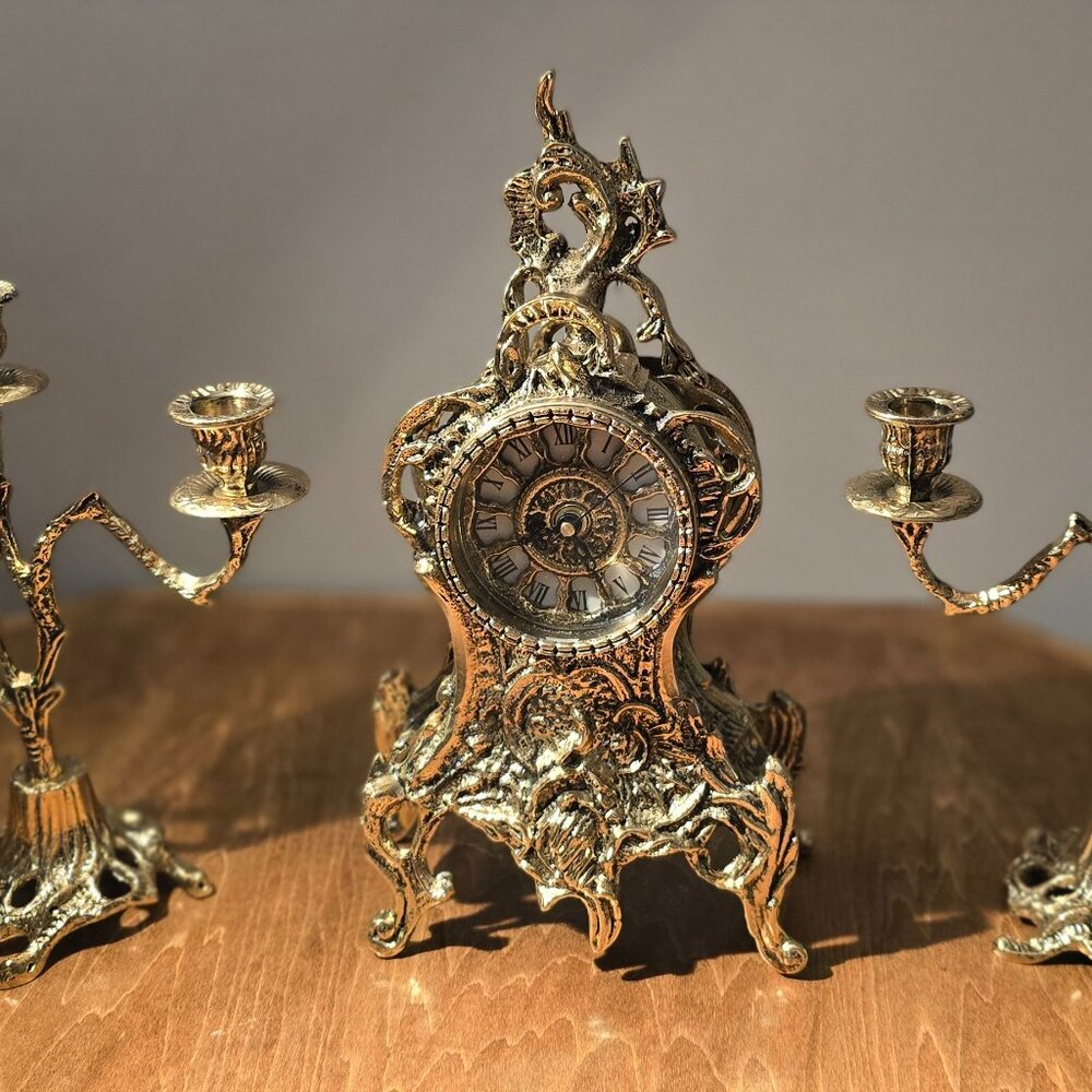 Brass clock with two candlesticks